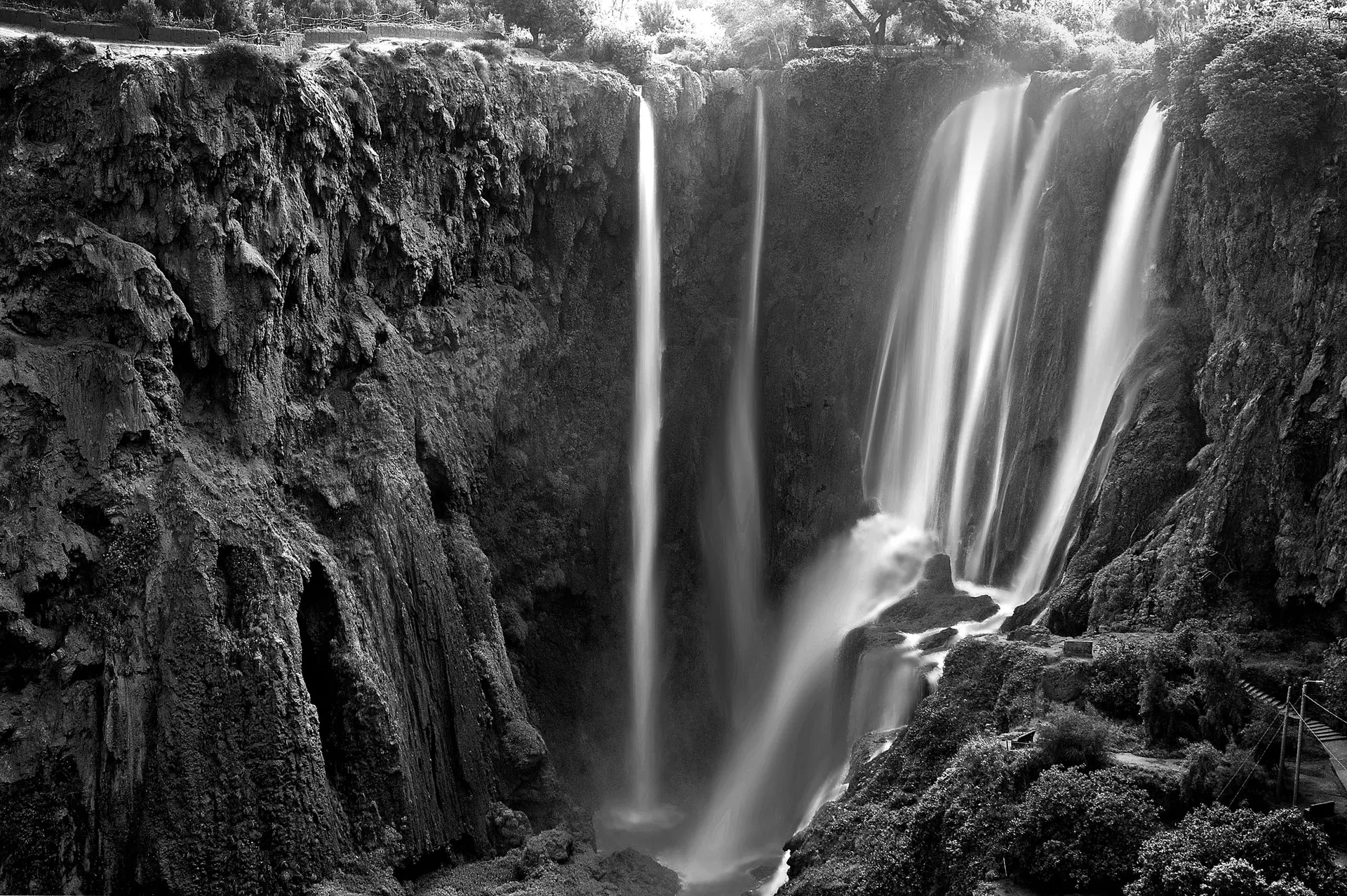 Black and white capture of the scenic Ouzoud Falls in Beni-Mellal, Morocco.